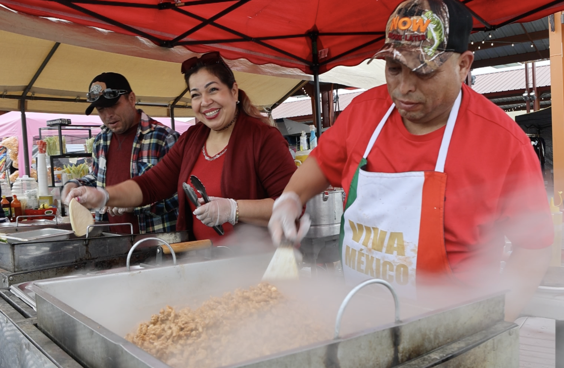 Staff at Tres Hermanos Tacos prepares meat filling and tortillas at Pasco’s Cinco de Mayo on Saturday, May 4. Larissa Babiak/Tri-City Herald