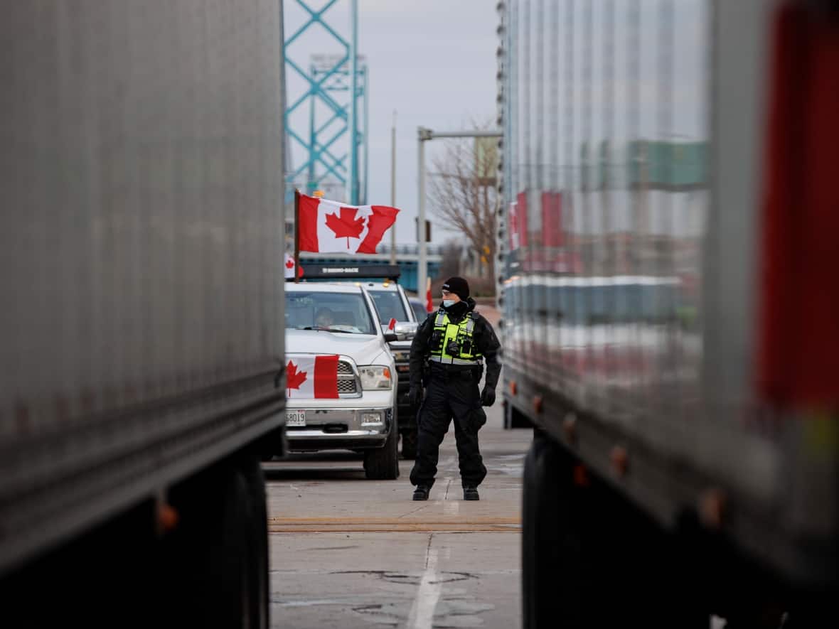 Police cleared vehicles from a blockade of the Ambassador Bridge in Windsor, Ont., on Saturday, though a number of protesters remained at the border crossing. (Evan Mitsui/CBC - image credit)