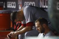 St. Louis Cardinals starting pitcher Jack Flaherty sits in the dugout after the Washington Nationals scored four runs during the third inning of Game 3 of the baseball National League Championship Series Monday, Oct. 14, 2019, in Washington. (AP Photo/Patrick Semansky)