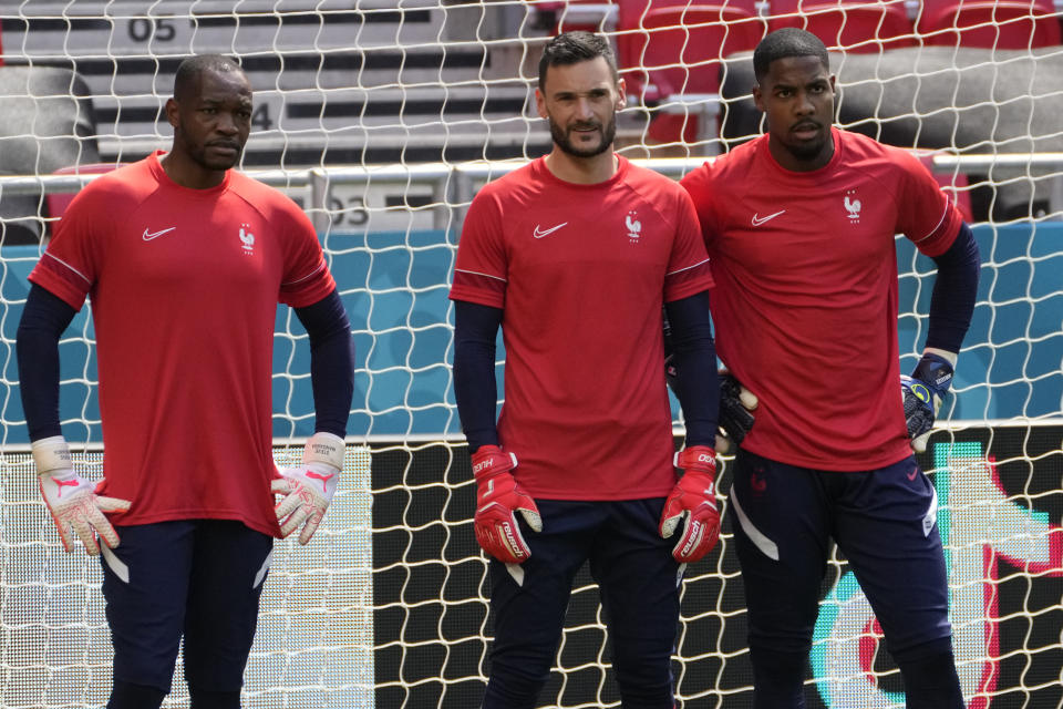 France's goalkeeper Hugo Lloris, center, France's goalkeeper Mike Maignan, right, and France's goalkeeper Steve Mandanda attend a training session at the Ferenc Puskas stadium in Budapest, Hungary, Friday, June 18, 2021, the day before the Euro 2020 soccer championship group F match between Hungary and France. (AP Photo/Darko Bandic)