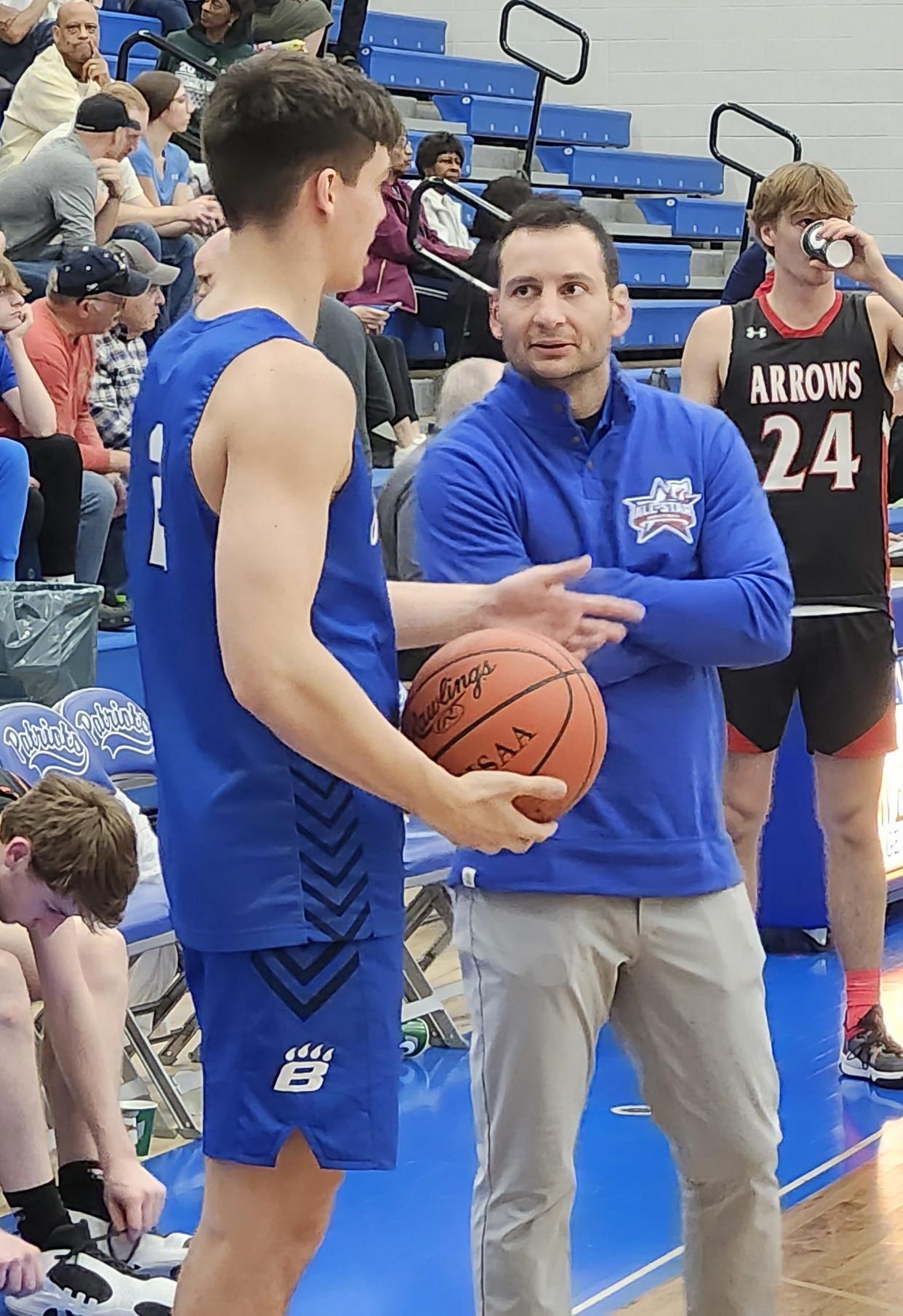 Hilliard Bradley's Cade Norris, left, talks to Olentangy Orange coach Anthony Calo at halftime of the Ohio High School Basketball Coaches Association North-South game Friday night at Olentangy Liberty. Calo coached the South team, for which Norris played. The two faced each other the past four years as rivals in the OCC-Central.
