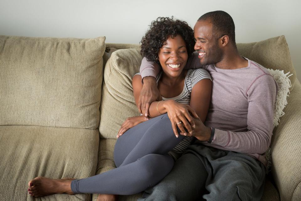 Couple cuddling on couch