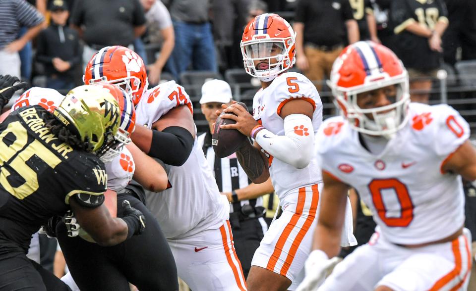 Clemson quarterback D.J. Uiagalelei (5) passes near Wake Forest defensive lineman Dion Bergan, Jr. (95) during the second overtime at Truist Field in Winston-Salem, North Carolina Saturday, September 24, 2022.  