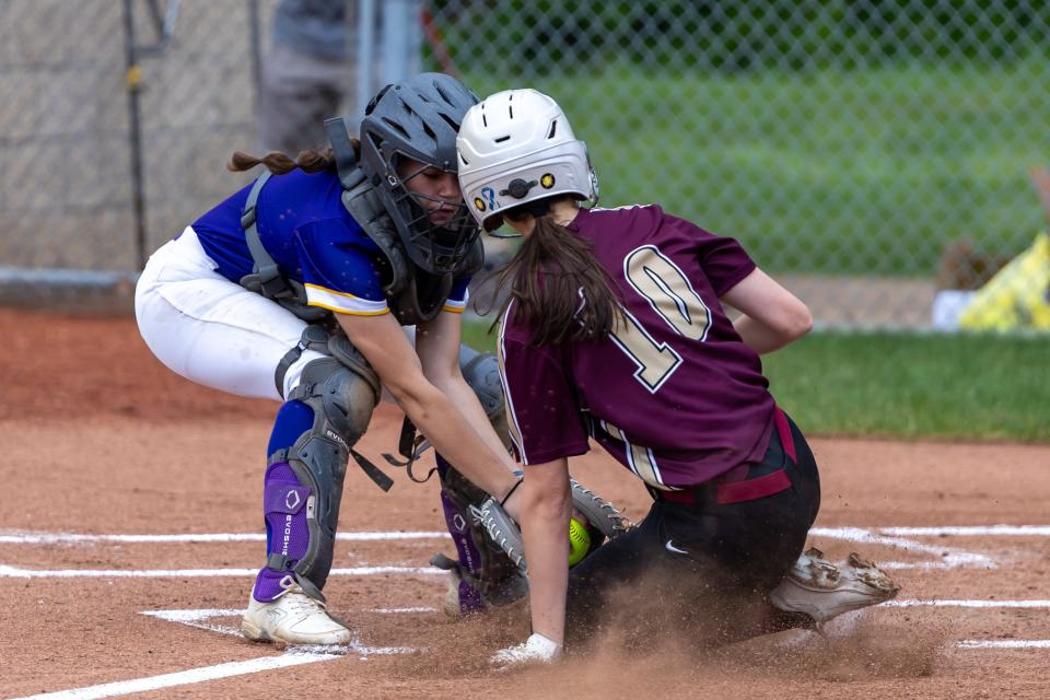 Leann Walzer (7) delivers a tag on Steel Valley's Abby Curran (10) during OLSH's first round matchup in the WPIAL Class 2A playoffs against Steel Valley Tuesday afternoon at North Allegheny High School.
