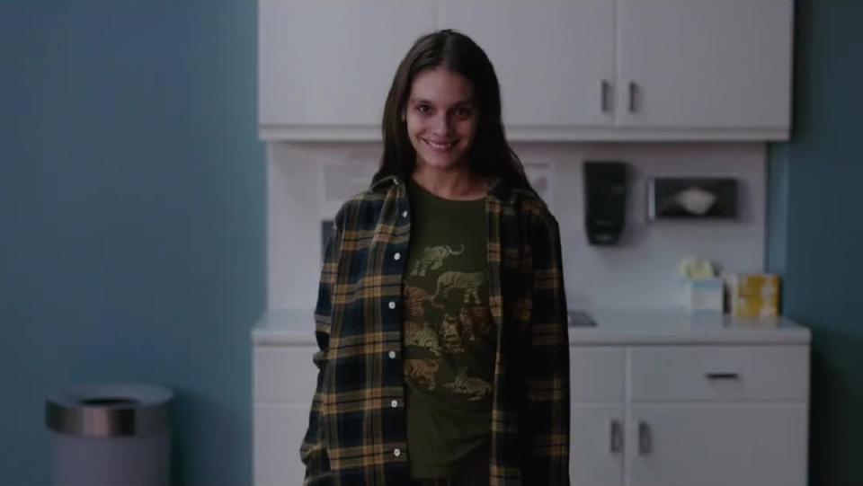 Laura (Caitlin Stasey) gives an uncanny grin in Smile.