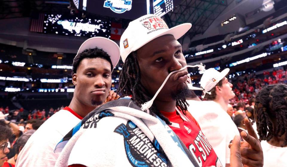 N.C. State’s DJ Burns Jr. (30) and Ernest Ross (24) pose after the Wolfpack’s 76-64 victory over Duke in their NCAA Tournament Elite Eight matchup at the American Airlines Center in Dallas, Texas, Sunday, March 31, 2024.