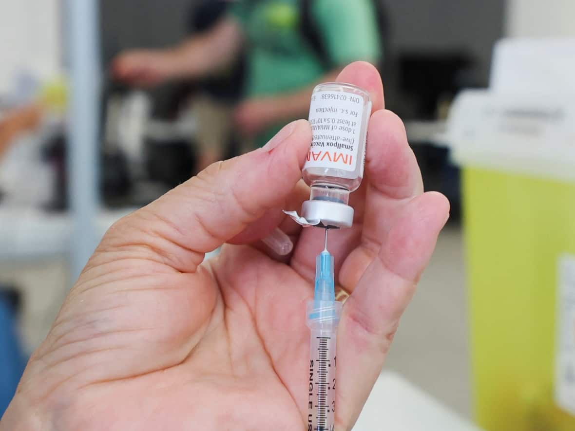 A health-care worker prepares a syringe filled with the monkeypox vaccine in Montreal. Vaccination clinics are being prepared for Vancouver's gay community ahead of the city's Pride parade. (Christinne Muschi/Reuters - image credit)