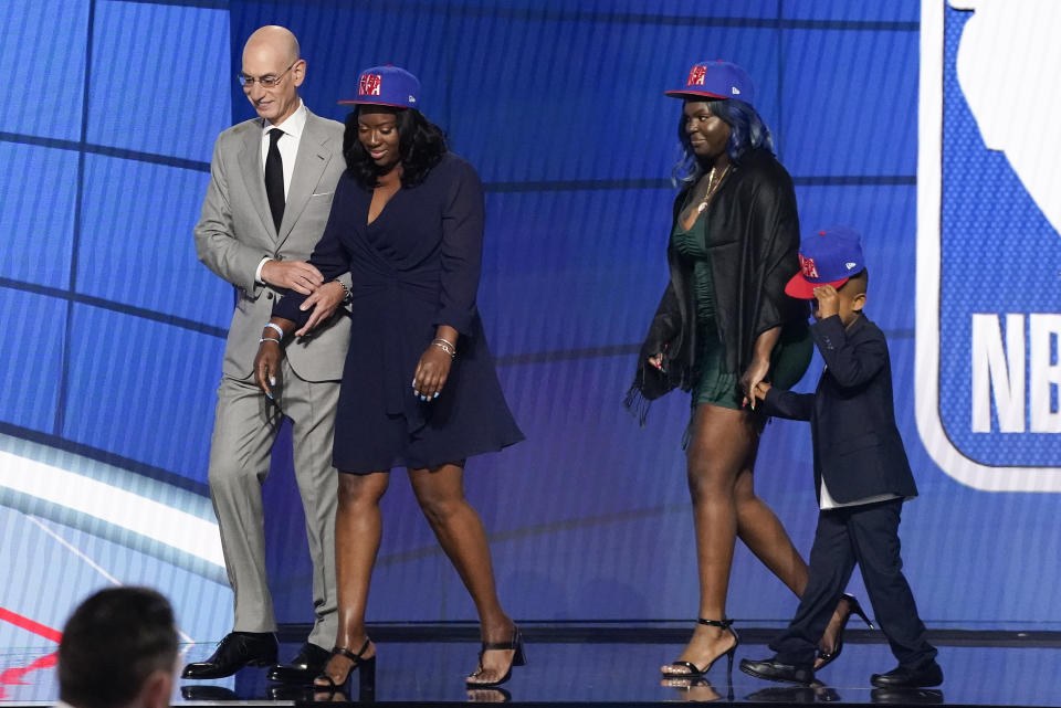NBA Commissioner Adam Silver escorts relatives of former Kentucky guard Terrence Clarke after a tribute to Clarke during the NBA basketball draft, Thursday, July 29, 2021, in New York. Clarke was killed in a car accident in April 2021. (AP Photo/Corey Sipkin)