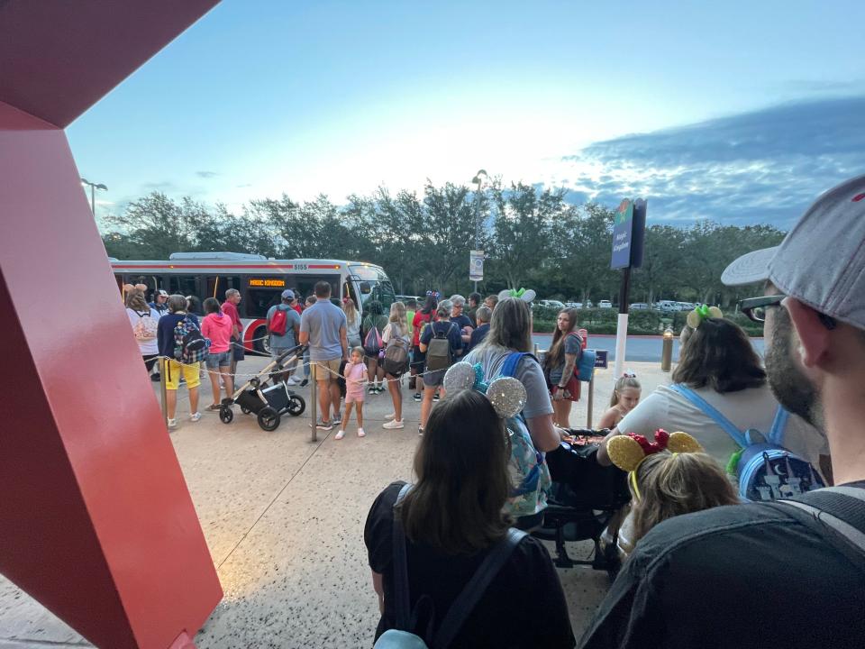 line of people waiting for bus at disney world resort