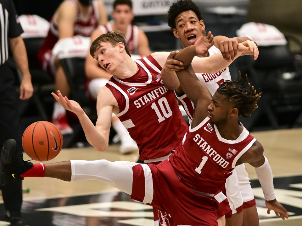 Stanford forward Max Murrell (10), guard Daejon Davis (1), and Washington State center Dishon Jackson (21) fight for a rebound during the first half of an NCAA college basketball game, Saturday, Feb. 20, 2021, in Pullman, Wash. (AP Photo/Pete Caster)