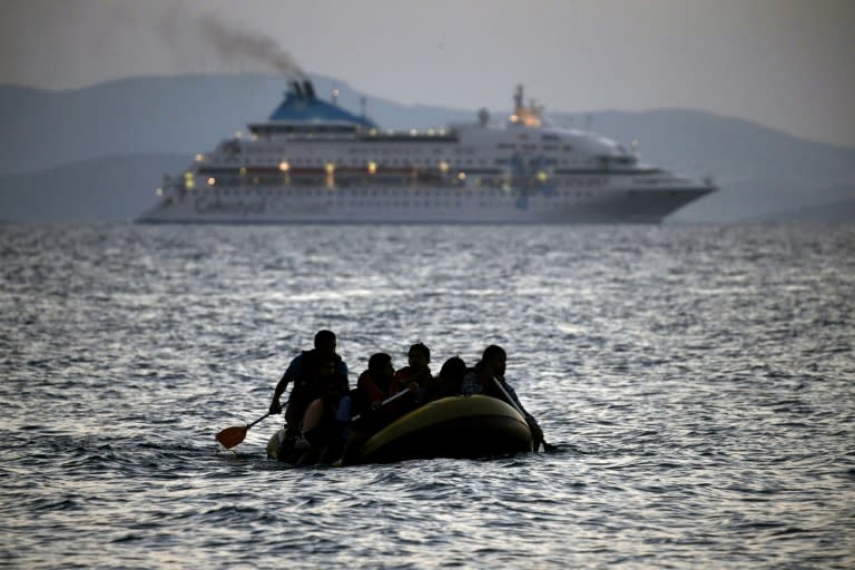 Migrants arrive on the shore of Kos island on a small dinghy on August 19, 2015