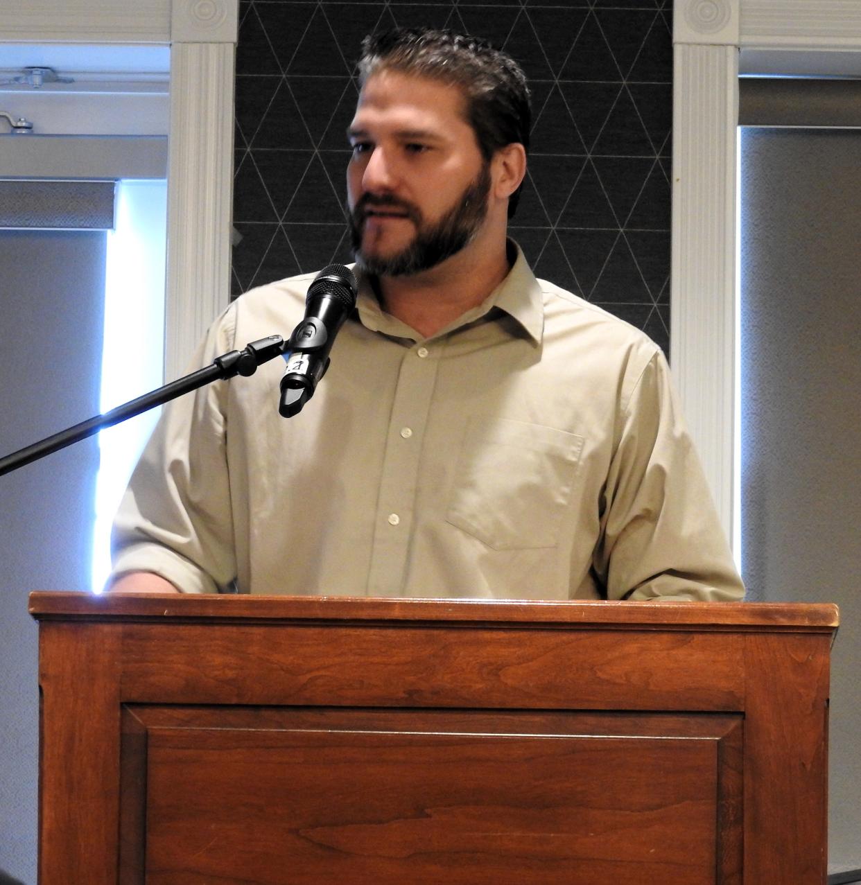 Caleb Munholand, president of HV Coil, receives the Small Manufacturer Excellence Award at a recent meeting of the Eastern Ohio Development Alliance.