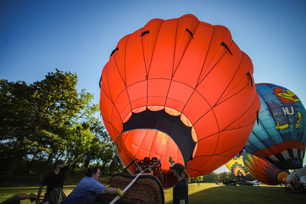 Gregg Sturge inflates his hot-air balloon Fireball at the kick-off start to the FireLake Fireflight Balloon Fest Thursday, Aug. 11, 2022, in Shawnee.