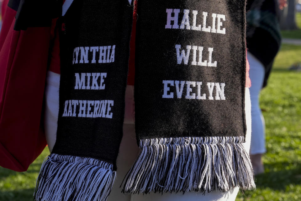 A person wears a scarf with the names of the victims of the Covenant School shooting during the Linking Arms for Change human chain Wednesday, March 27, 2024, in Nashville, Tenn. (AP Photo/George Walker IV)