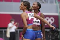 Sydney McLaughlin of the United States, left, celebrates with teammate Dalilah Muhammad after winning the final of the women's 400-meter hurdles at the 2020 Summer Olympics, Wednesday, Aug. 4, 2021, in Tokyo. (AP Photo/Matthias Schrader)