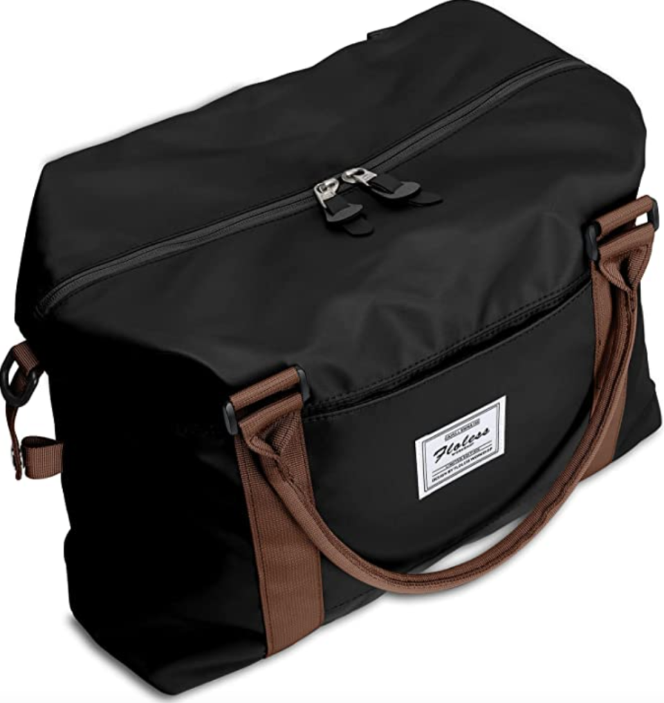 carry-on bag, BJLFS Weekender Bag in black with brown handle (Photo via Amazon)