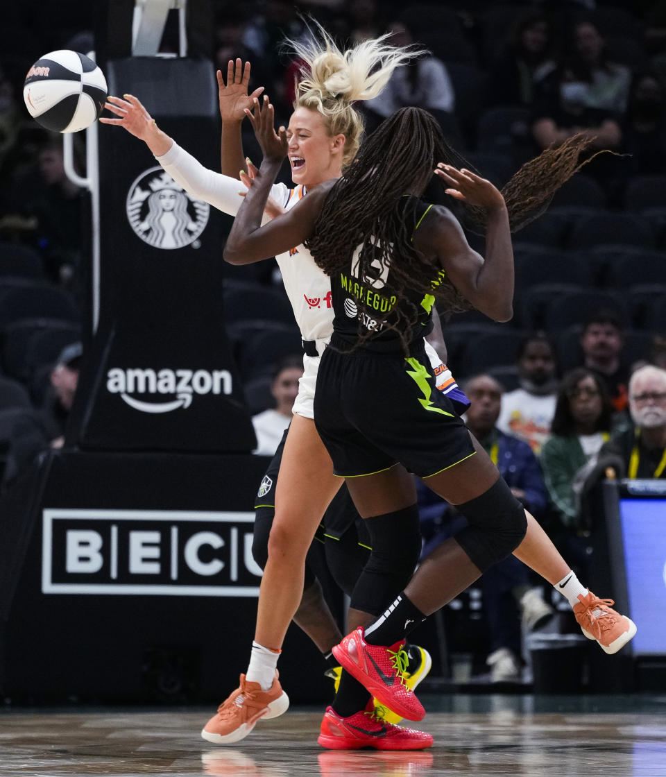 Phoenix Mercury guard Sophie Cunningham, rear, collides with Seattle Storm center Ezi Magbegor and is called for a foul during the first half of a WNBA basketball game Tuesday, June 4, 2024, in Seattle. (AP Photo/Lindsey Wasson)