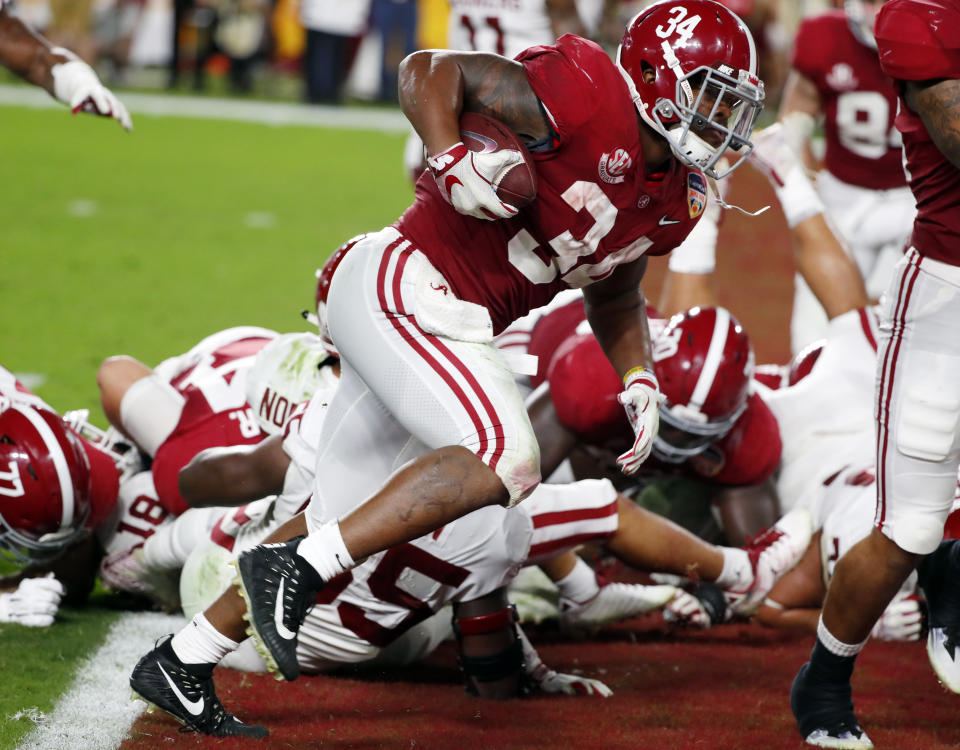 Alabama running back Damien Harris (34) scores a touchdown, during the first half of the Orange Bowl NCAA college football game against Oklahoma, Saturday, Dec. 29, 2018, in Miami Gardens, Fla. (AP Photo/Wilfredo Lee)