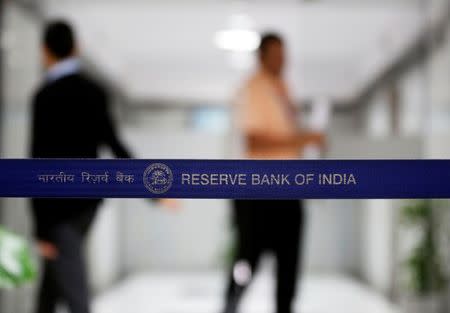 People walk past a barricade inside the Reserve Bank of India (RBI) headquarters in Mumbai, June 7, 2017. REUTERS/Shailesh Andrade/Files