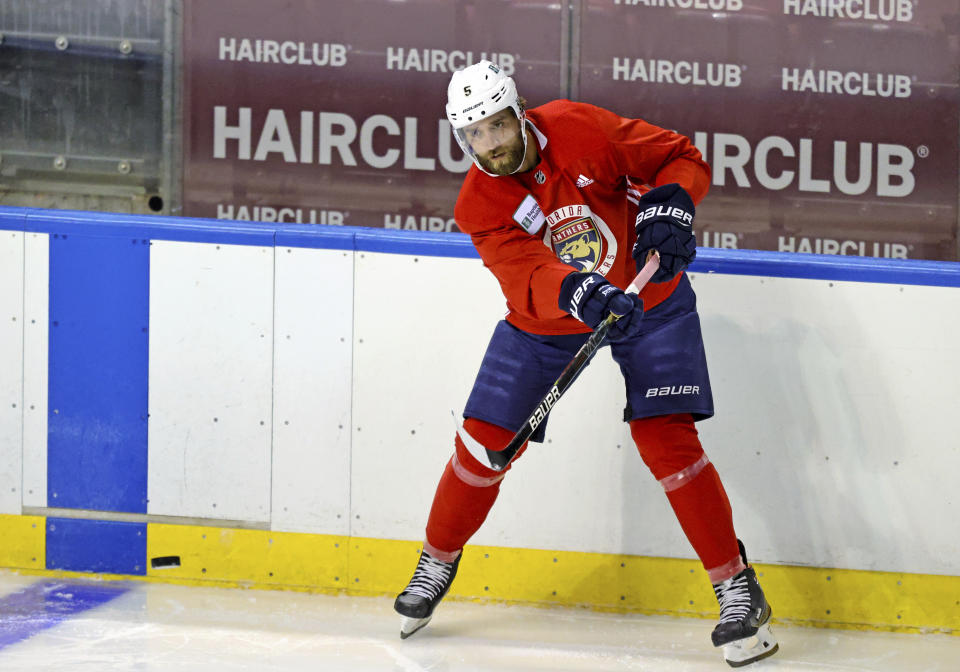 Florida Panthers defenseman Aaron Ekblad passes the puck during an NHL hockey training camp Thursday, Sept. 23, 2021, in Sunrise, Fla. (David Santiago/Miami Herald via AP)