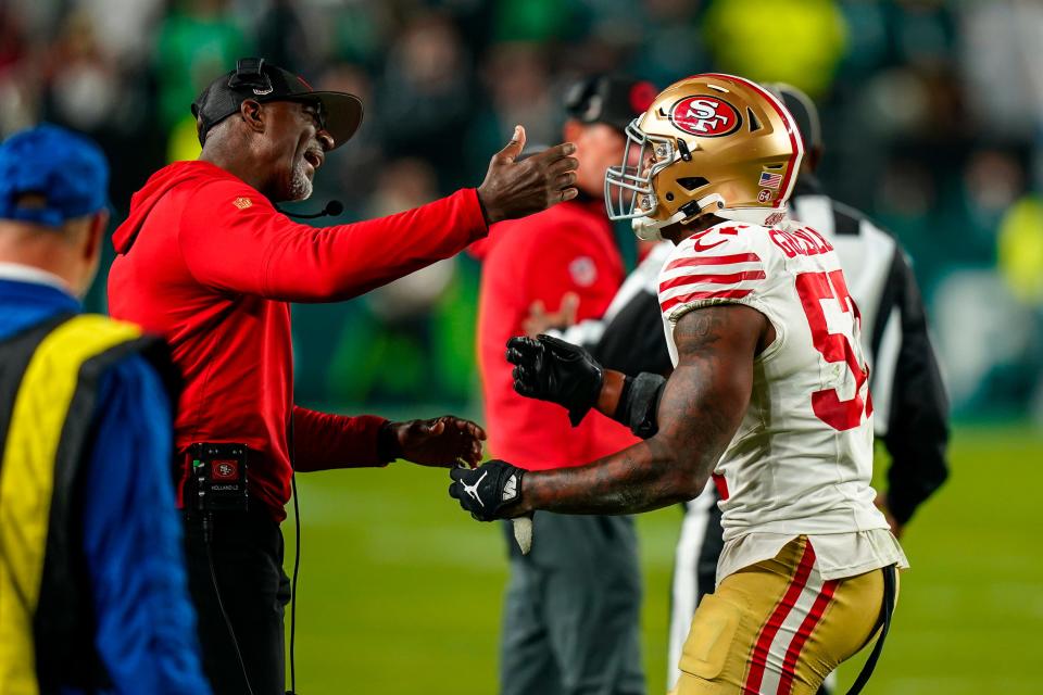 San Francisco 49ers linebacker Dre Greenlaw, right, talks to linebackers coach Johnny Holland after being ejected from the game during the second half of an NFL football game against the Philadelphia Eagles, Sunday, Dec. 3, 2023, in Philadelphia. (AP Photo/Chris Szagola)