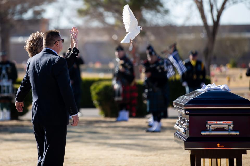 Rosanne Allen, the widow of El Paso police chief Greg Allen, let goes of a dove at Allen's funeral ceremony at Evergreen Cemetery East El Paso on Friday, Jan. 27, 2023.