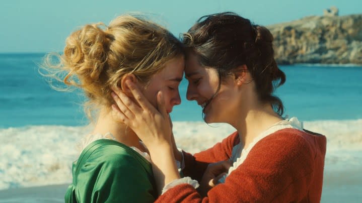 Adèle Haenel and Noémie Merlant stand near the ocean in Portrait of a Lady on Fire.