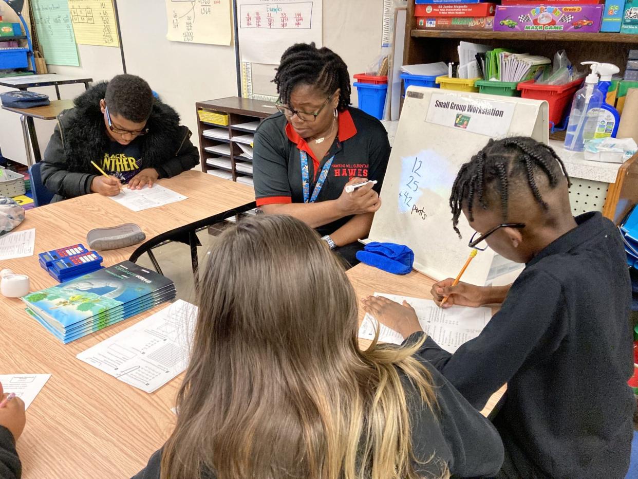 Kimberly Martin, a math teacher at Hawkins Mills Elementary, instructs a small group in her class.