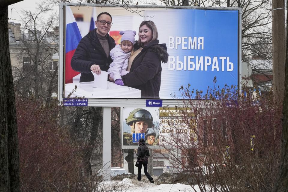 FILE - A woman walks past a billboard promoting the upcoming presidential election with the words in Russian "Time to vote" in St. Petersburg, Russia, Thursday, March 7, 2024. (AP Photo/Dmitri Lovetsky, File)