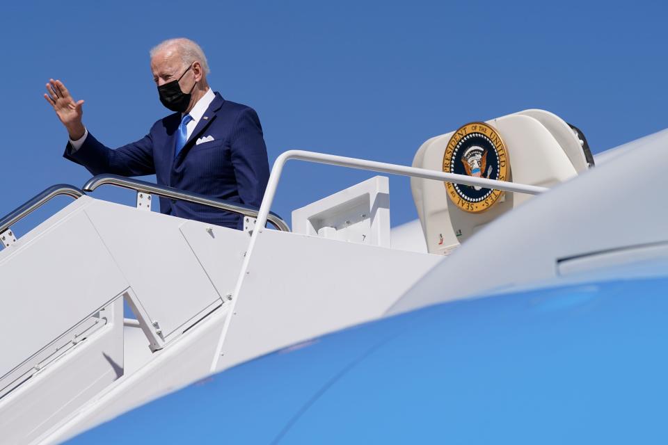 President Joe Biden waves as he boards Air Force One at Andrews Air Force Base in Maryland on March 26, 2021.