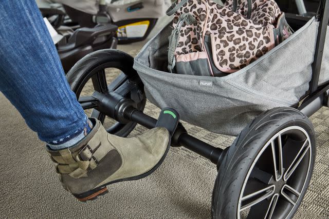 <p>Verywell Family / Dera Burreson</p> Parenting editor testing the brakes on the Nuna Mixx stroller, our best luxury pick.