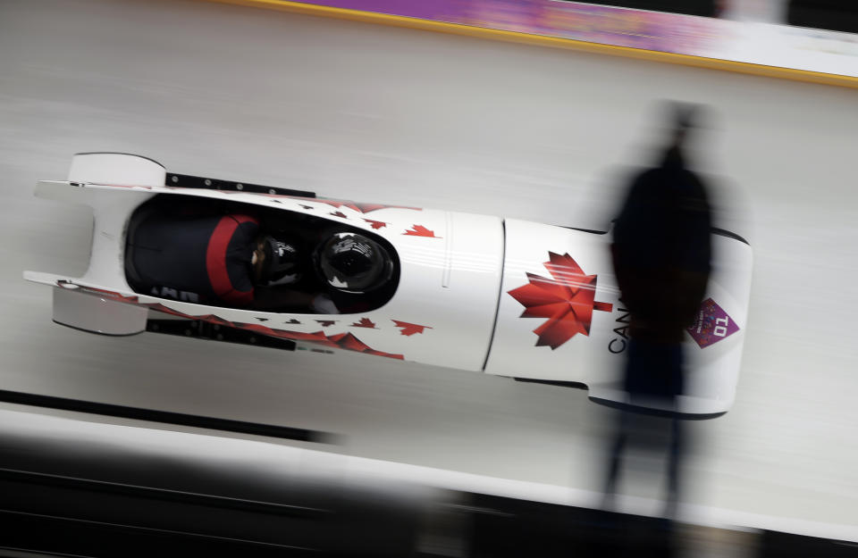The team from Canada CAN-1, piloted Kaillie Humphries with brakeman Heather Moyse, speed down the track during the women's two-man bobsled competition at the 2014 Winter Olympics, Tuesday, Feb. 18, 2014, in Krasnaya Polyana, Russia. (AP Photo/Michael Sohn)