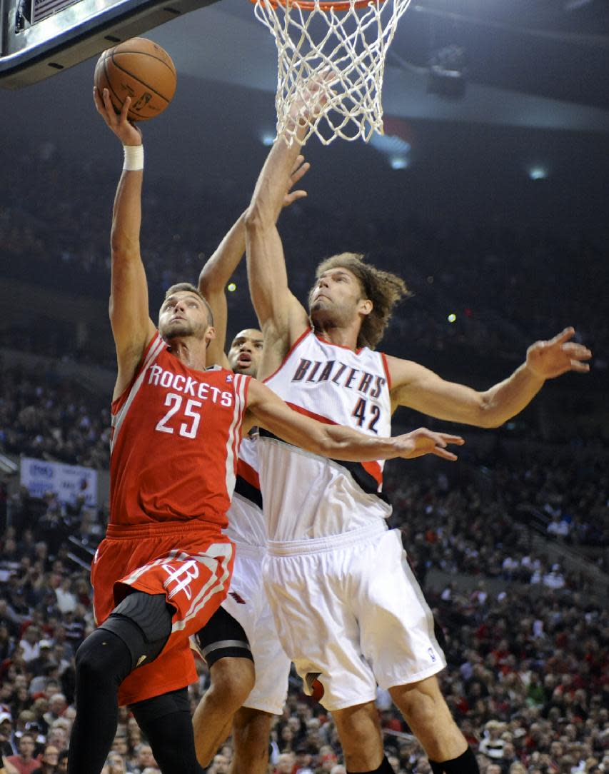 Houston Rockets' Chandler Parsons (25) shoots against Portland Trail Blazers' Robin Lopez (42) and Nicolas Batum during the first half of game four of an NBA basketball first-round playoff series game in Portland, Ore., Sunday March 30, 2014. (AP Photo/Greg Wahl-Stephens)