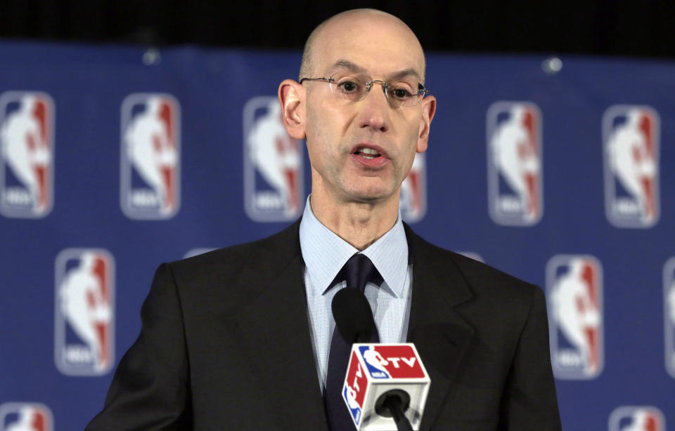 NBA Commissioner Adam Silver reads a statement during a news conference, in New York, Tuesday, April 29, 2014. Silver announced that he is banning Los Angeles Clipper owner Donald Sterling for life from the Clippers organization, in response to racist comments the league says he made in an audio recording. (AP Photo/Richard Drew)