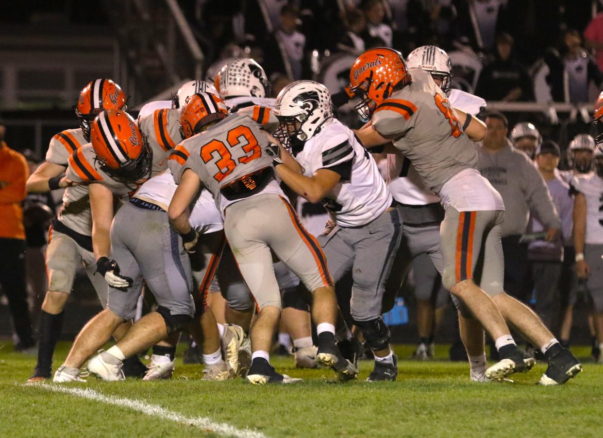 The Ridgewood defense swarms to shut to down Richmond Edison running back Talon McClurg during a 33-8 win in the Division V, Region 17 first round playoff game on Friday.