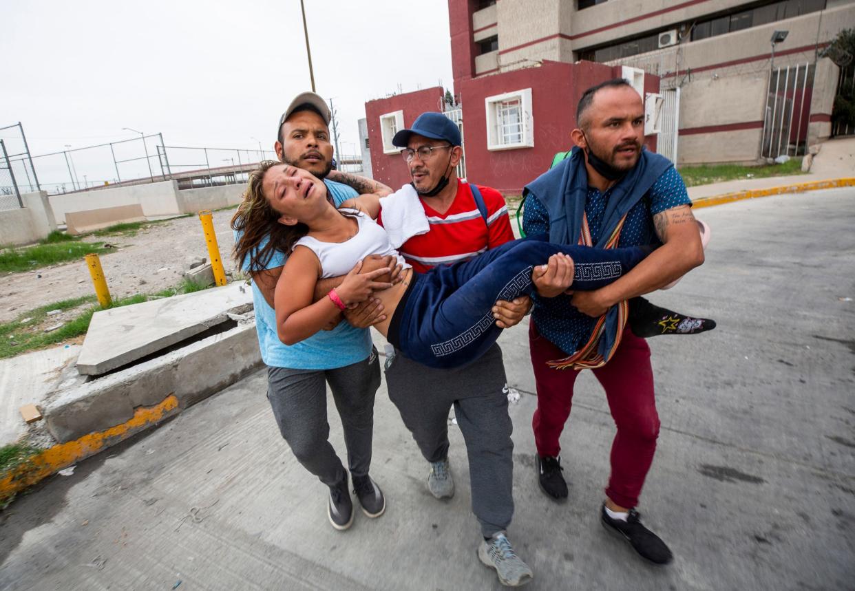 Maria de Los Angeles Croce is carried by her fellow Venezuelan migrants to a health clinic after she suffered an asthma attack and lost consciousness soon after being expelled from the U.S. to Ciudad Juarez on Oct. 14, 2022. Croce was one of hundeds of migrants who have been expelled from the U.S after hoping to seek asylum.