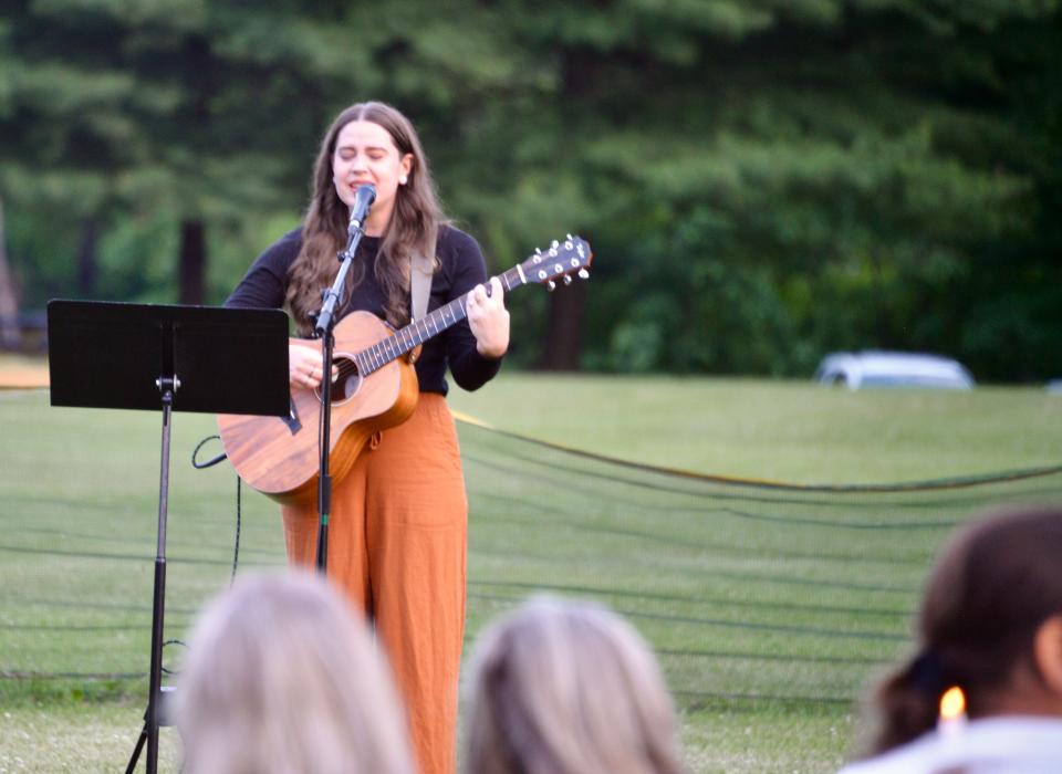 Sharayah Bishop, of Lifehouse Church in Hagerstown, performs four verses of "Amazing Grace" Saturday night during the Smithsburg vigil for the victims of the June 9 shooting at nearby Columbia Machine.