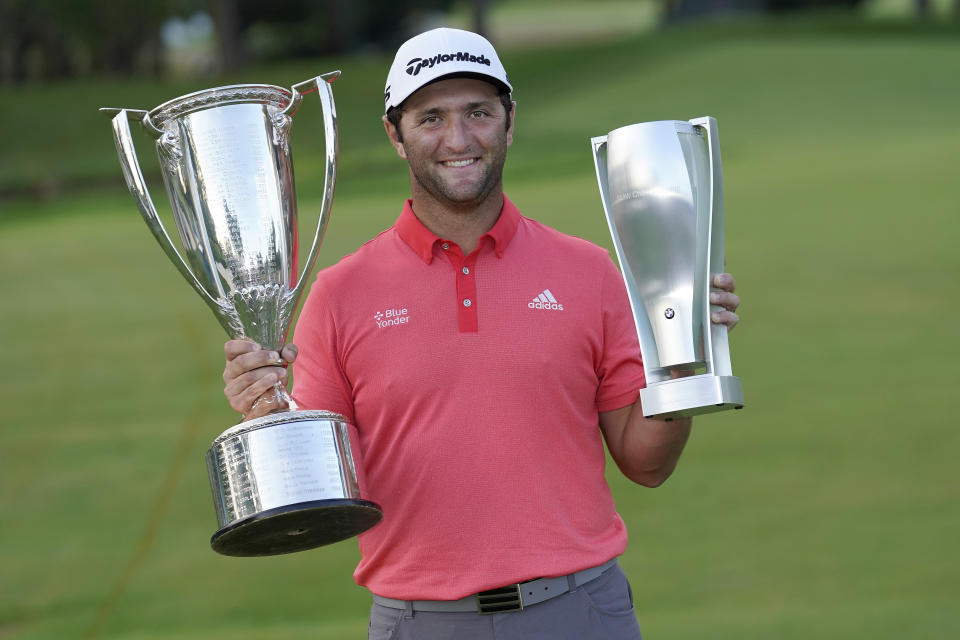 Jon Rahm poses with the J.K. Wadley trophy, left, and the BMW trophy after winning the BMW Championship golf tournament at the Olympia Fields Country Club in Olympia Fields, Ill., Sunday, Aug. 30, 2020. (AP Photo/Charles Rex Arbogast)