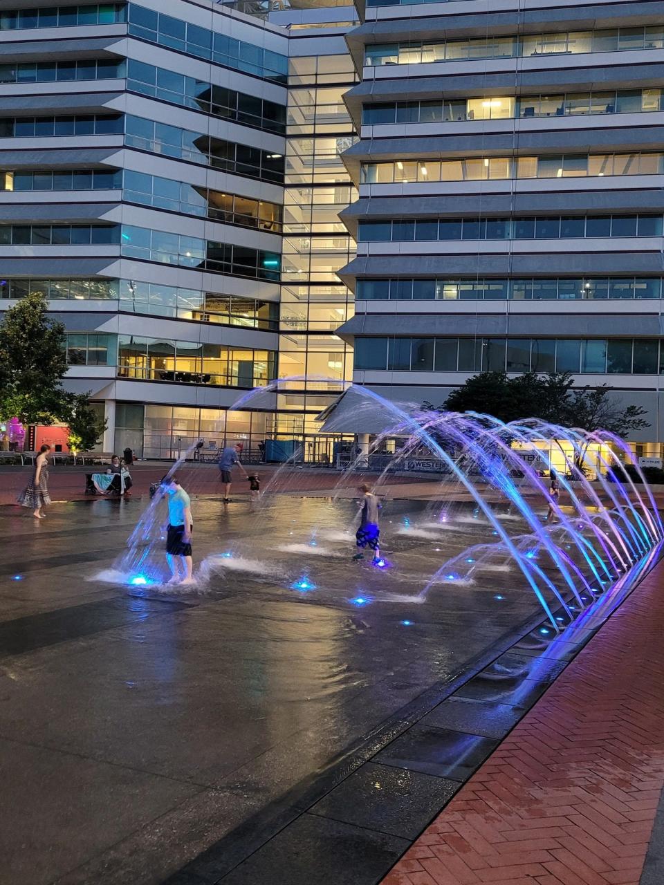 Children revel in the Lauridsen Fountain on Cowles Commons after its reactivation July 1, 2022. Usually switched on after Memorial Day, it had been shut down for installation of new lighting, a project delayed by supply chain issues.