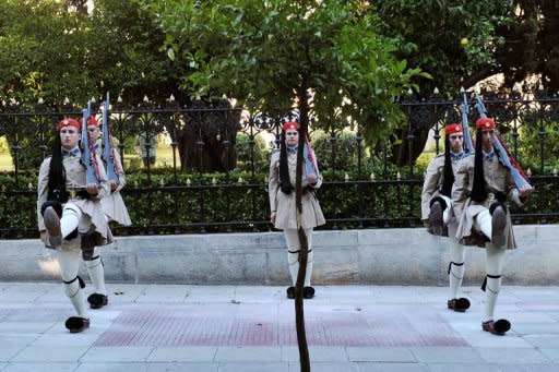 Presidental guards perform during a changing of the guard ceremony outside the presidental palace in Athens. Greece named a new cabinet to end two months of political deadlock on Thursday and said it would aim to revise the terms of an unpopular EU-IMF bailout deal without risking its eurozone membership