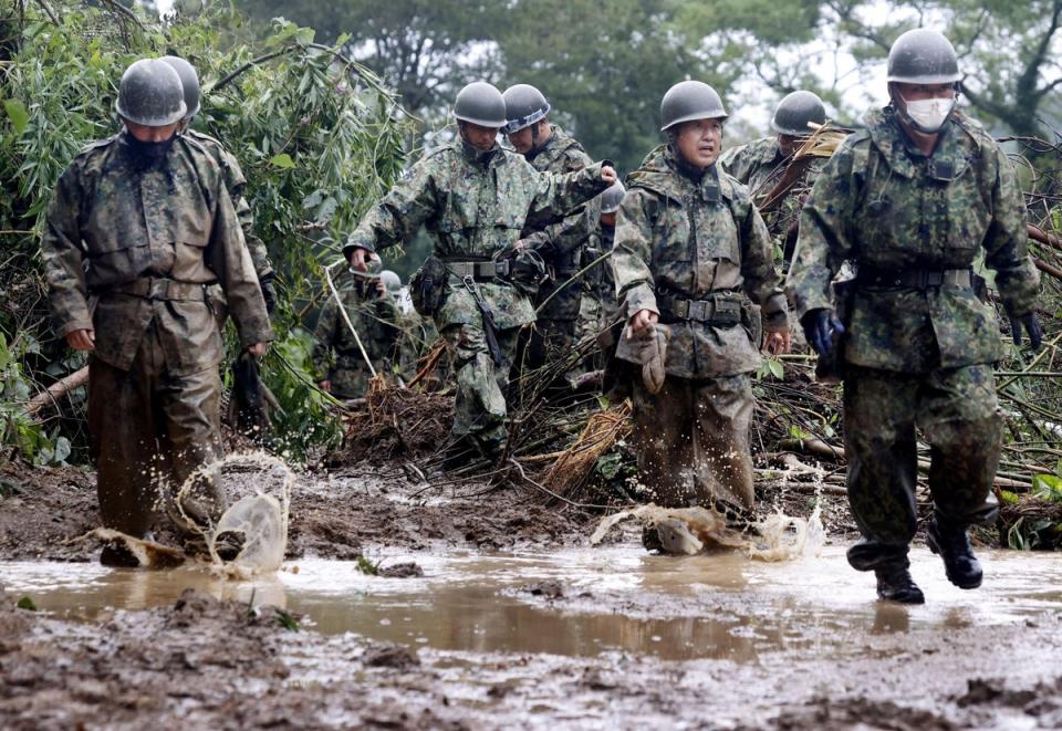 Japanese Self-Defence Force soldiers conduct a search and rescue operation at the site of a landslide caused by Typhoon Nanmadol in Mimata Town, Miyazaki prefecture on Monday (Reuters)