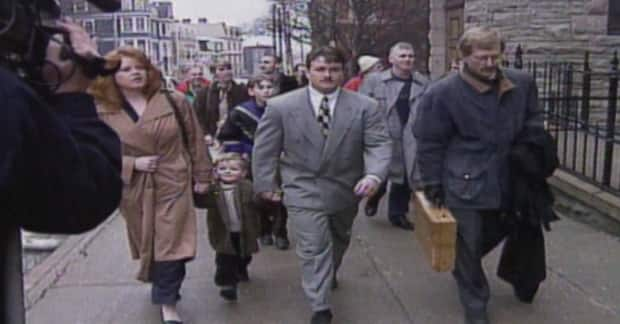 Greg Parsons walks into Supreme Court with his wife Tina and young son after DNA evidence cleared him of killing his mother, Catherine Carroll, in 1998.