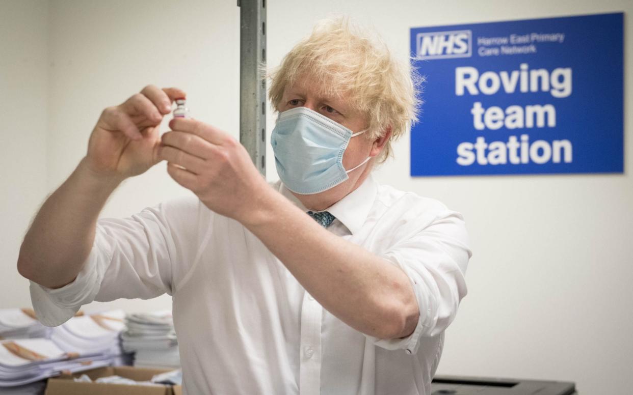 Boris Johnson sees how a dose of the Oxford/AstraZeneca Covid 19 vaccine is prepared during a visit to Barnet FC's ground at The Hive, north London -  STEFAN ROUSSEAU/AFP
