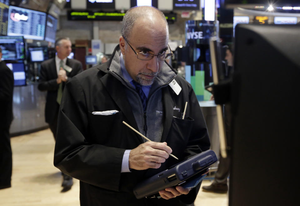 Trader John Liotti works on the floor of the New York Stock Exchange Wednesday, Feb. 5, 2014. The U.S. stock market is edging lower in early trading after a modest recovery the day before. (AP Photo/Richard Drew)