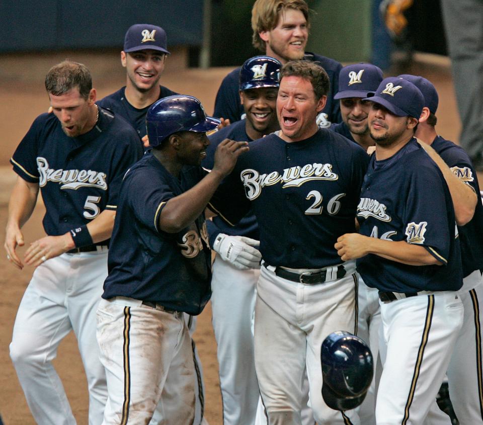 Damian Miller (26) is mobbed by jubilant teammates after hitting his walk off home run in the 11th inning at Miller Park,