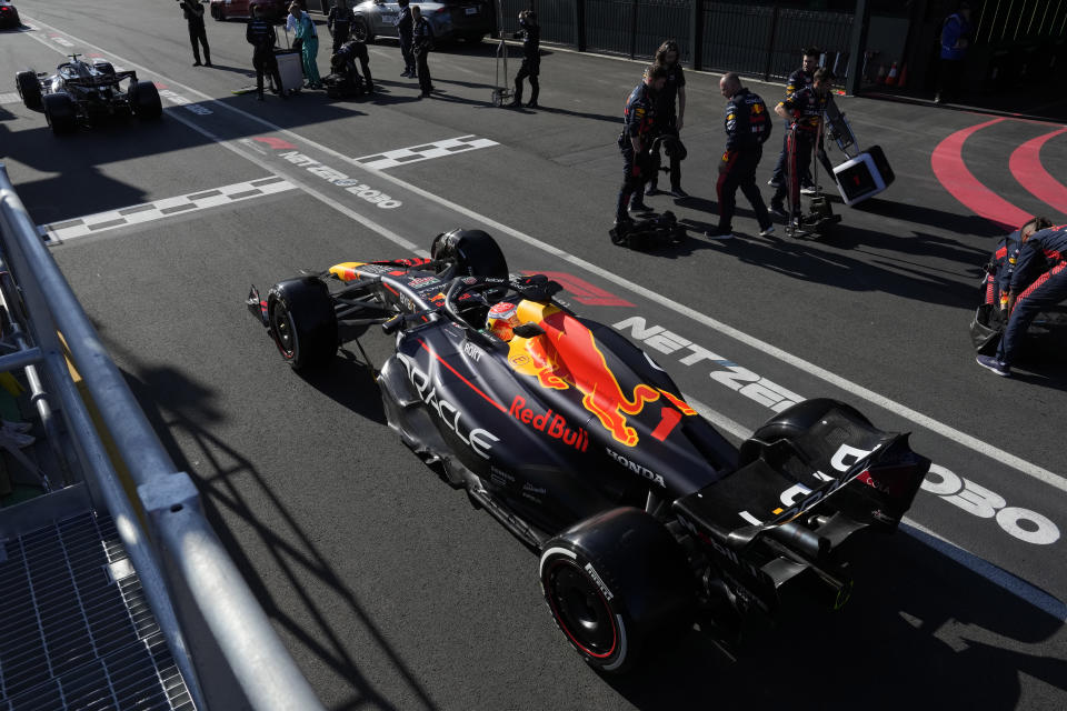 Red Bull driver Max Verstappen of Netherlands sits in his car in pit lane waiting for a restart of the Australian Formula One Grand Prix at Albert Park in Melbourne, Sunday, April 2, 2023. (Simon Baker/Pool via AP)