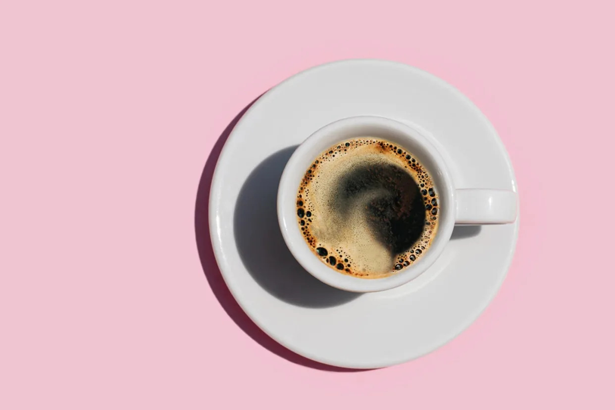 a shot of coffee on a pink background