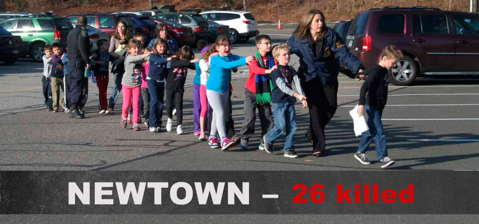 Two Connecticut State Police officers accompany a class of students and two adults out of Sandy Hook Elementary School on Dec. 14, 2012, in Newtown, Conn. (Photo: Shannon Hicks/Newtown Bee/Polaris)