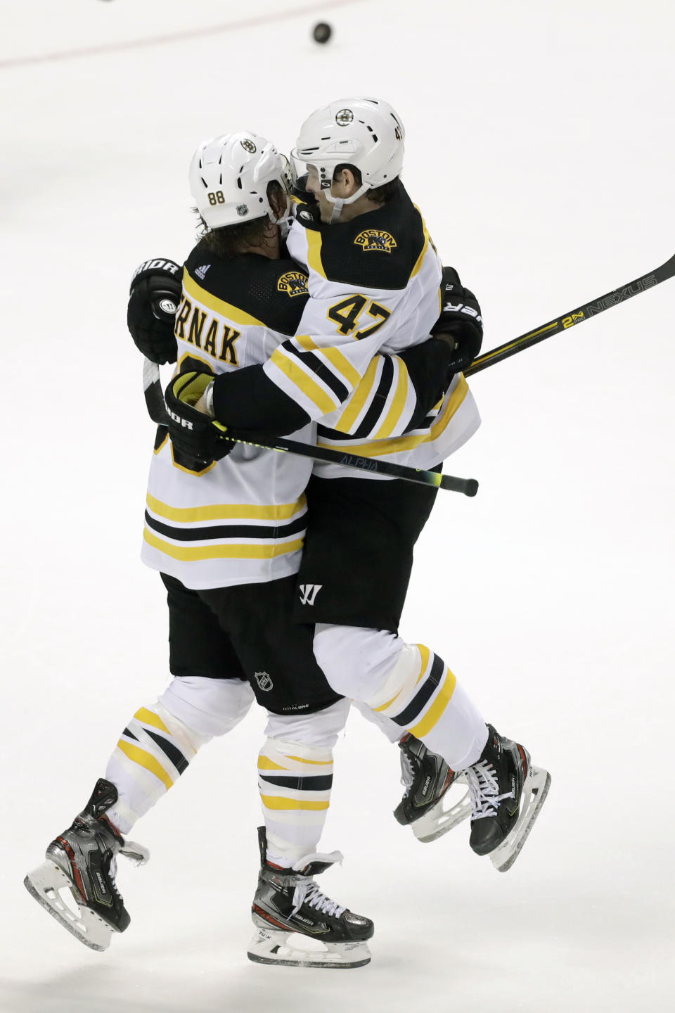 Boston Bruins right wing David Pastrnak (88) celebrates with defenseman Torey Krug (47) after Krug scored the winning goal during an overtime period of an NHL hockey game against the Florida Panthers, Thursday, March 5, 2020, in Sunrise, Fla. (AP Photo/Wilfredo Lee)