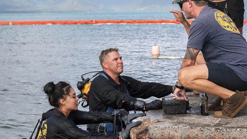 In this photo provided by U.S. Marine Corps, U.S. Navy sailors, retrieved the aircraft flight recorder from a downed U.S. Navy P-8A Poseidon and are debriefed in waters just off the runway at Marine Corps Air Station Kaneohe Bay, Marine Corps Base Hawaii, Thursday, Nov. 23, 2023. (Lance Cpl. Hunter Jones/U.S. Marine Corps via AP)